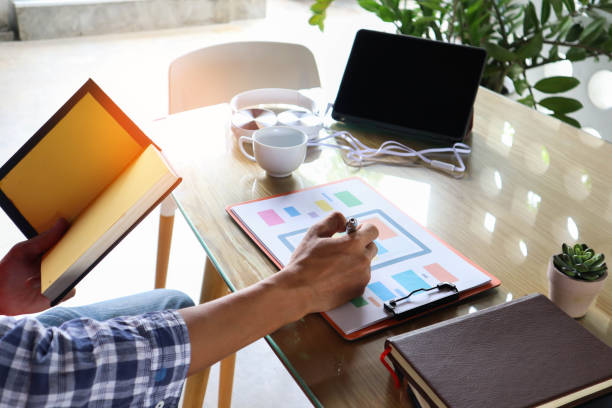 businessman hand working use statistics on the graph to study online trading investment profits.concept