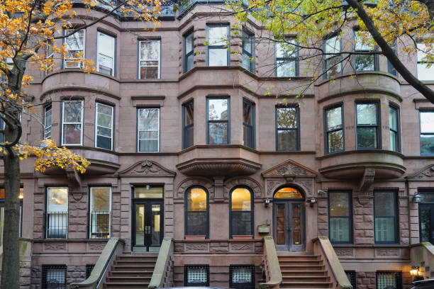 new york residential street with brownstone style apartment buildings - brownstone stok fotoğraflar ve resimler