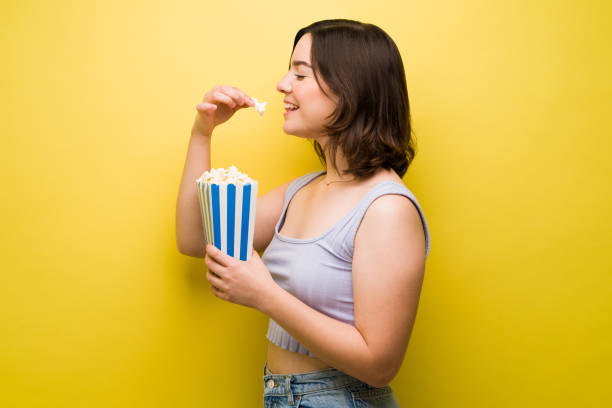 istock Smiling while eating popcorn at the movies 1357557369