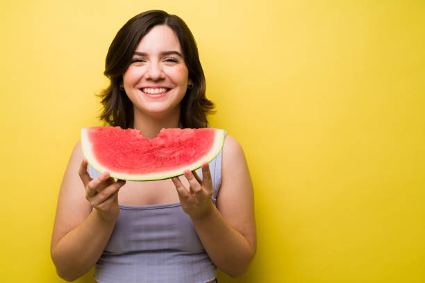 istock Gorgeous woman enjoying eating fruit 1357557454