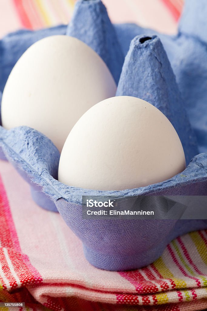 White eggs Close-up of white eggs in a blue carton Animal Egg Stock Photo