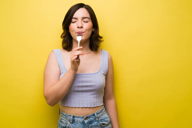 istock Hungry woman enjoying lunch 1357558849