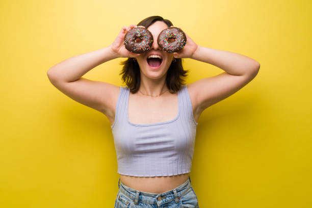 istock Excited woman loves doughnuts 1357558922