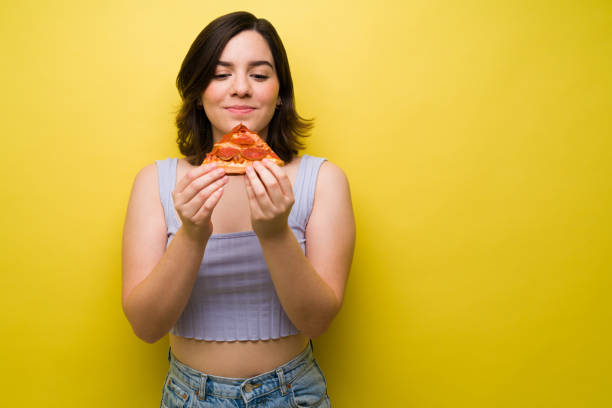 istock Beautiful woman craving pizza 1357558984