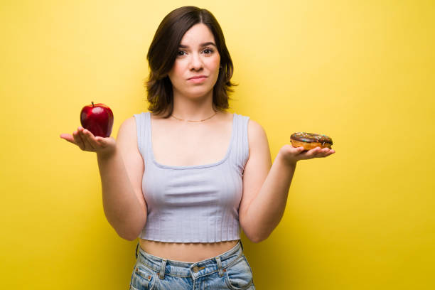 istock Sad woman choosing food 1357559024