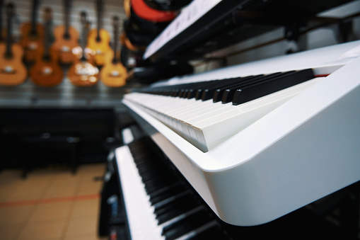 Modern electronic keyboard synthesizers in a music store. Digital pianos in store