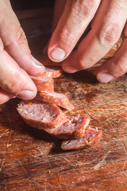 istock Sliced smoked calabrese sausage in a wooden table,copy space 1357559829
