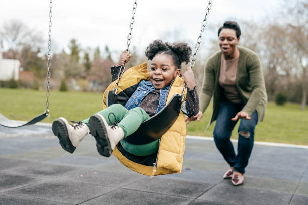 istock Mother playing with her  little daughter outside 1357560083