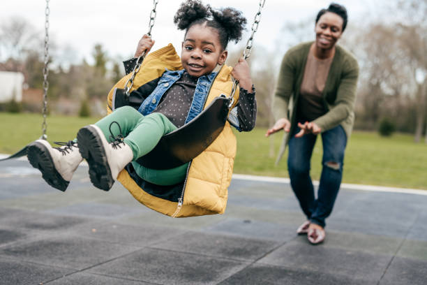 istock Mother playing with her  little daughter outside 1357560091