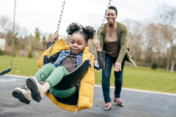 istock Mother playing with her  little daughter outside 1357560114