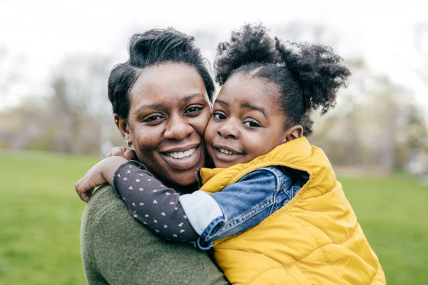 istock Mother playing with her  little daughter outside 1357560134