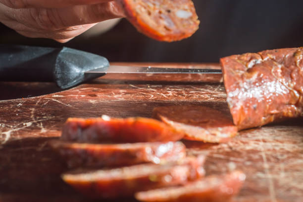istock Sliced smoked calabrese sausage in a wooden table,copy space 1357560823
