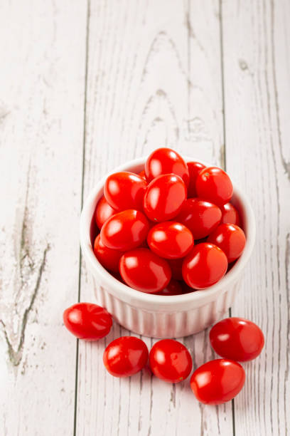 istock Fresh grape tomatoes in a bowl on the table. 1357562902