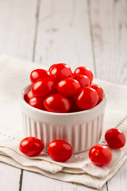 istock Fresh grape tomatoes in a bowl on the table. 1357563438
