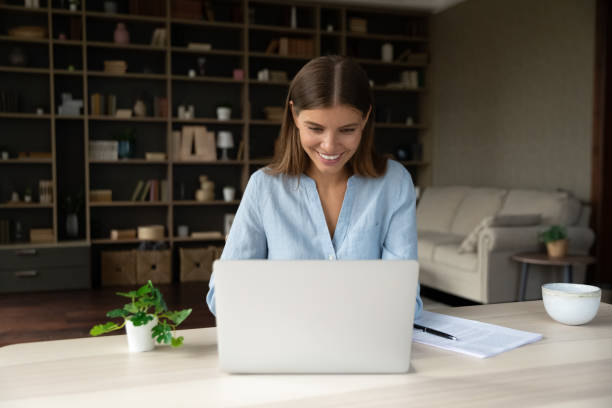 istock Happy young businesswoman working on computer in office. 1357564402