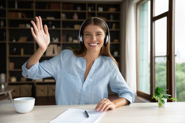 istock Smiling attractive young woman starting video call. 1357564405