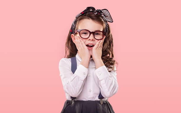 istock Surprised little girl on pink background 1357570096