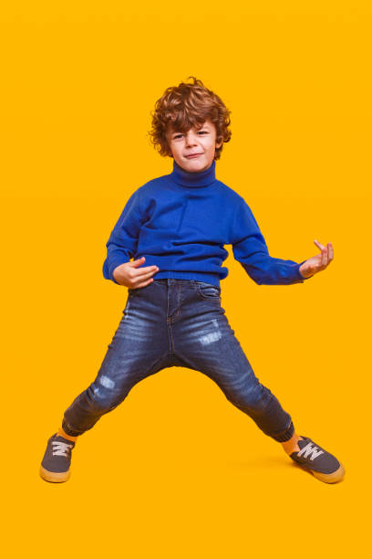 istock Funny kid pretending to play guitar 1357570159