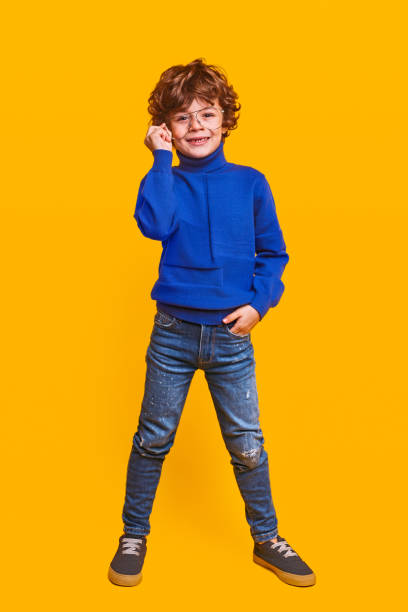 istock Positive stylish child adjusting glasses 1357570176