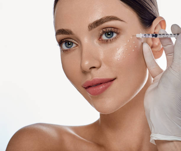 Biorevitalization, anti-aging procedure. Beautiful woman getting beauty injections with hyaluronic acid for smoothing of face mimic wrinkles stock photo