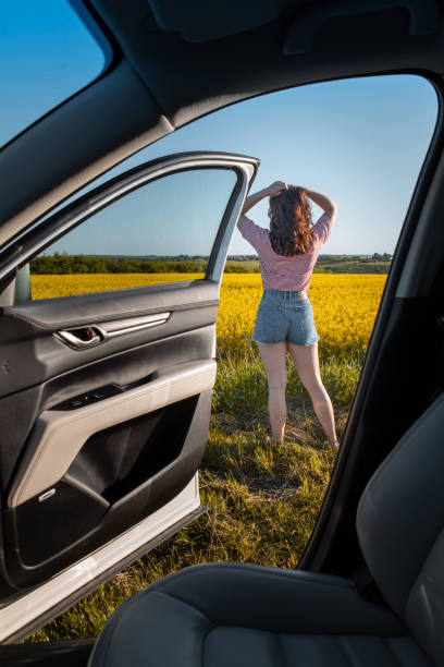 istock woman stop to enjoy sunset at road trip 1357577270