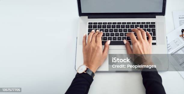 High Angle Shot Shot Of An Unrecognisable Businesswoman Typing On A Laptop Keyboard In An Office Stock Photo - Download Image Now