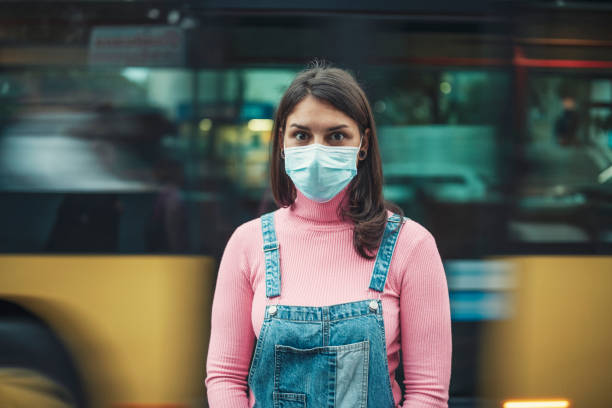 istock Woman Wearing Protective Face Mask In Town 1357579701