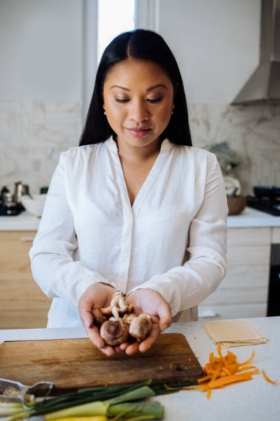 istock Beautiful Woman Preparing Healthy Meal in her Kitchen 1357580596