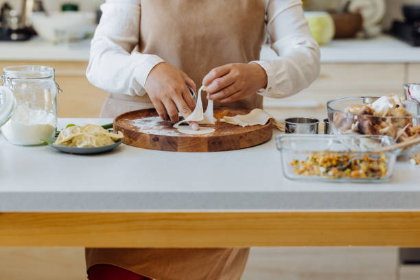 istock An Anonymous Woman Preparing Healthy Meal in her Kitchen 1357580797