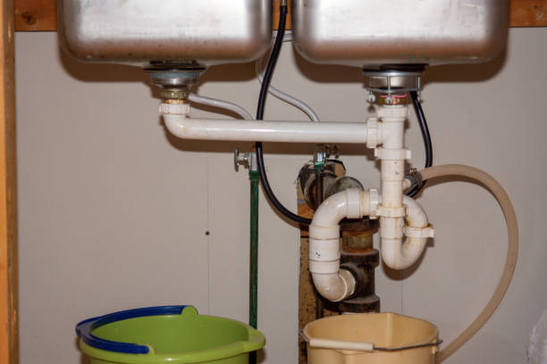 istock Kitchen Remodel Closeup of Under Sink Plumbing with Buckets 1357584407