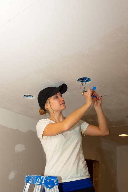 istock Kitchen Remodel Young Woman Working with Electrical Wires 1357584727