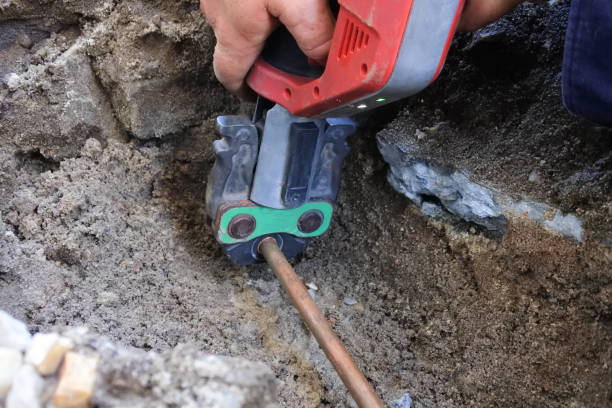 istock Plumber fixing an underground hot water pipe leaking with a tool 1357589477