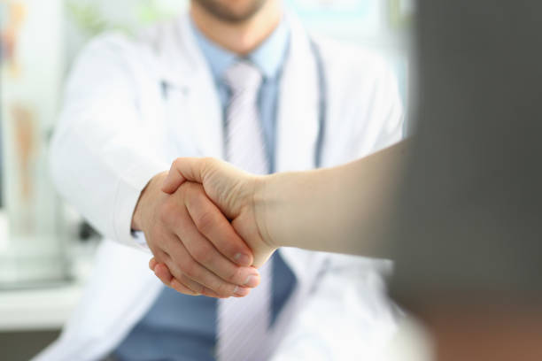 istock Doctor and patient shaking hands, grateful person 1357595905