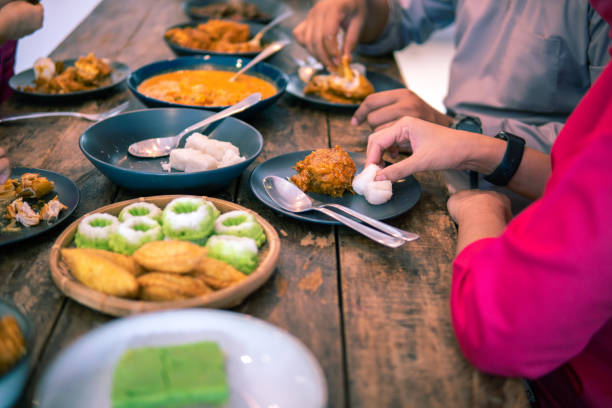 istock Tabletop view of human hands eating food 1357596399