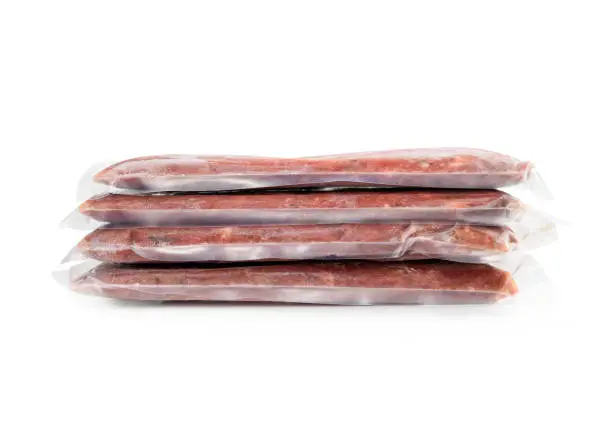 Front view. Ground chicken inclusive backs, necks, liver and heart. Concept for raw food diet for cats, dogs and pets. Isolated on white.
