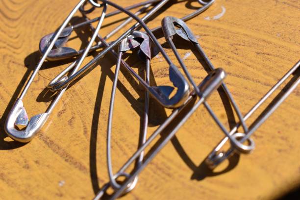 istock Safety pin on a wooden background. Selective focus. 1357601840