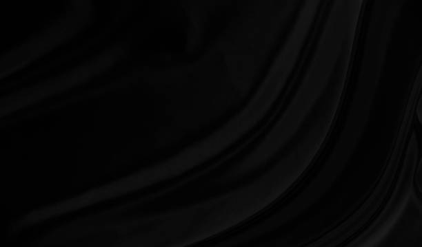 istock Black gray satin dark fabric texture luxurious shiny that is abstract silk cloth background with patterns soft waves blur beautiful. 1357608839