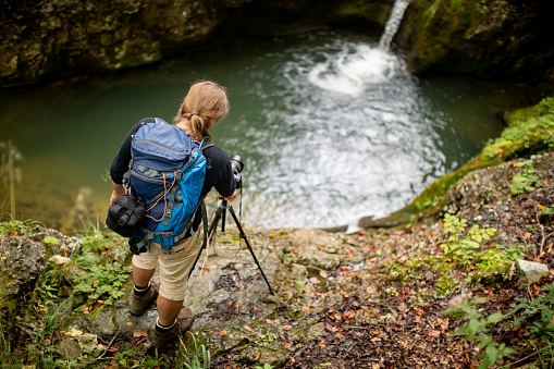 Nature Photographer Capturing an Image of a Flowing Water.
