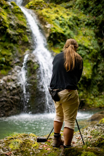 istock Nature Photographer Photographing Waterfall 1357613606