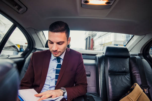 istock Businessman driving in a car 1357614109