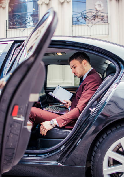 istock Man in purple suit looking at his notebook 1357614148