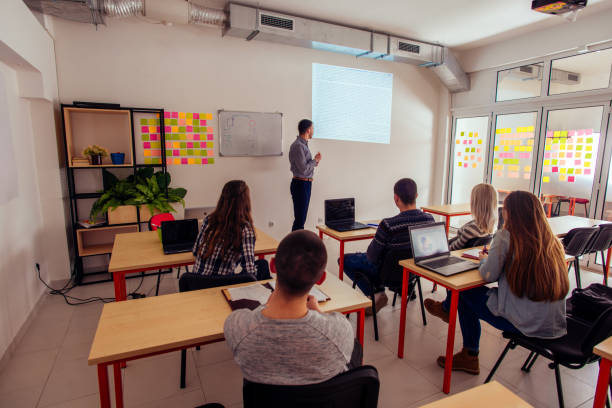Student having a presentation Young student is having a presentation in front of the class teacher projector stock pictures, royalty-free photos & images