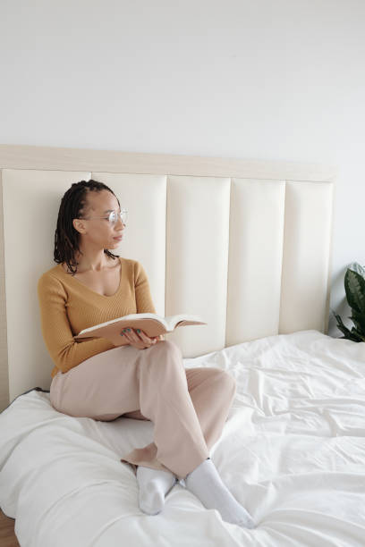 istock Pensive Woman with Opened Book 1357615956