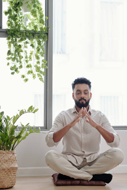 istock Relaxed Man Meditating at Home 1357615974