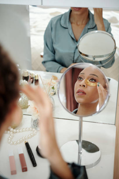 istock Woman Applying Moisturizing Undereye Patches 1357615984