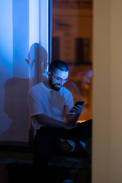 istock Exhausted businessman rest from work overtime play game on smartphone procrastinating in dark office 1357620685