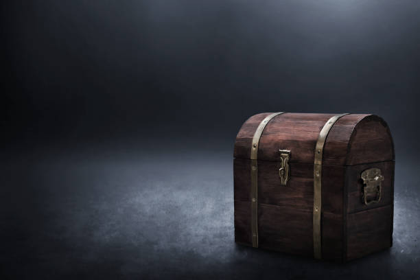 istock Wooden treasure chest on dark background 1357620902