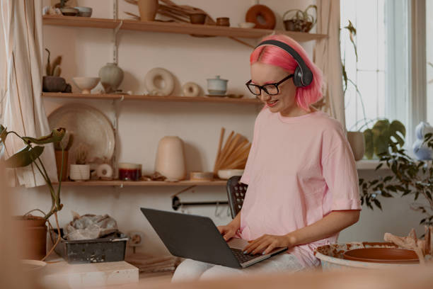 istock Positive female artisan having ceramics in workshop 1357623855