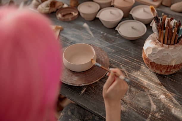 istock Young female potter engaged in craft in her workshop 1357623874