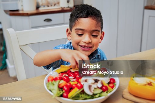 istock Shot of a little boy eating vegetables 1357624958